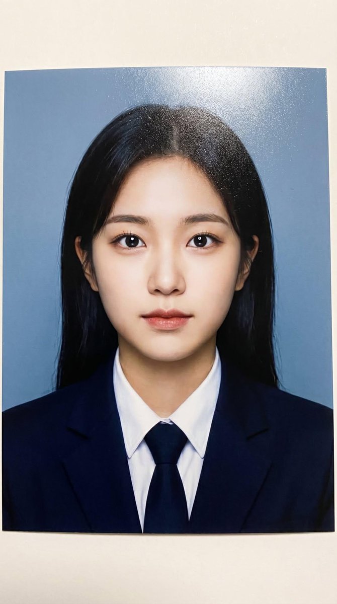 Photorealistic printed portrait of a young woman using the exact same face from the reference im 2