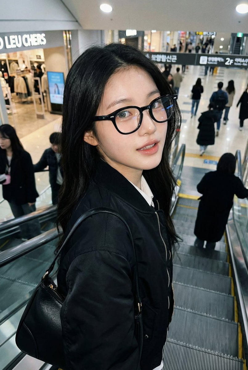 Photorealistic iPhone candid of a woman on an escalator, using the exact face and identity from  2